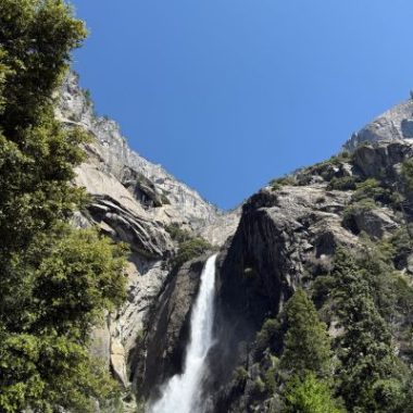 Water cascades down one of Yosemite National Park's dramatic granite cliffs, creating the breathtaking scenery that makes the park a favorite destination for California families.